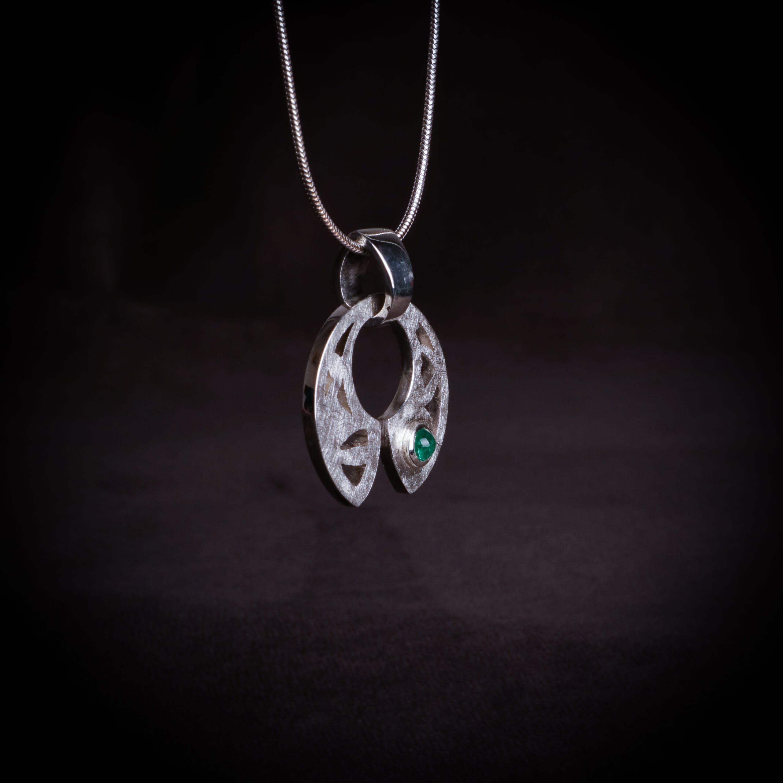 Emerald in silver pendant