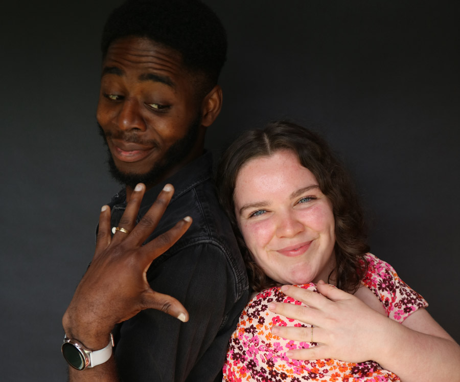 Cheeky faced happy couple showing off their new rings