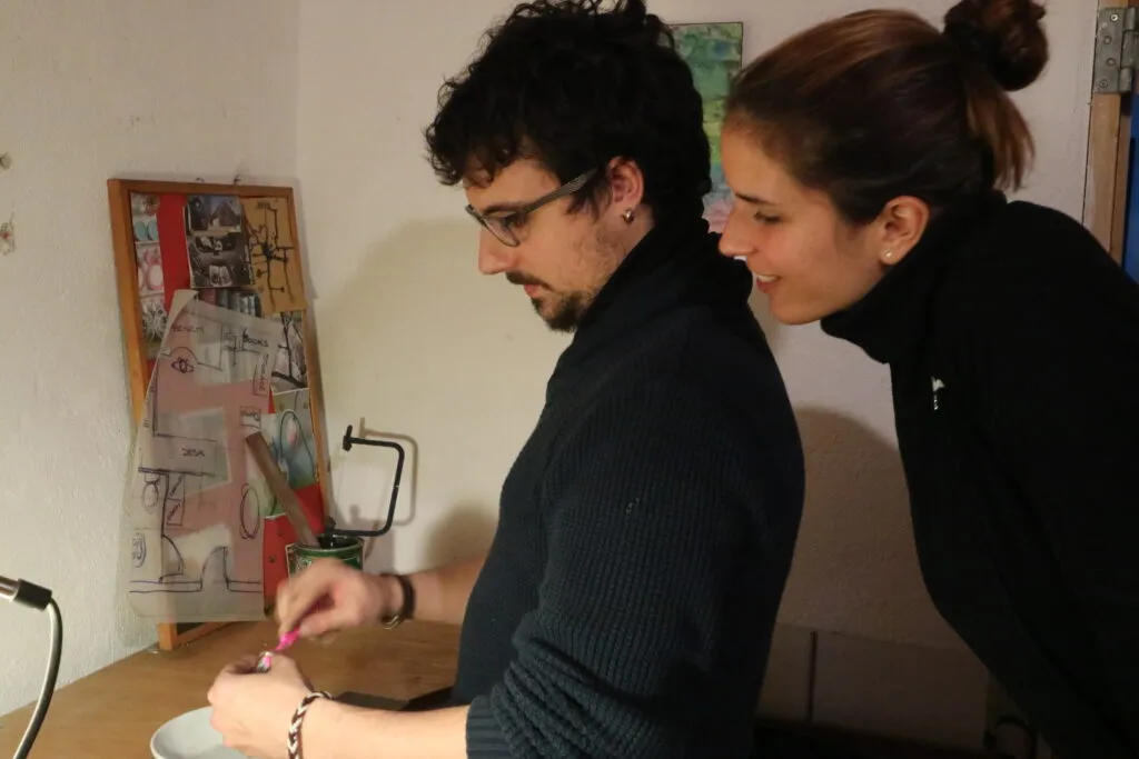 Two young people finishing their own wedding rings