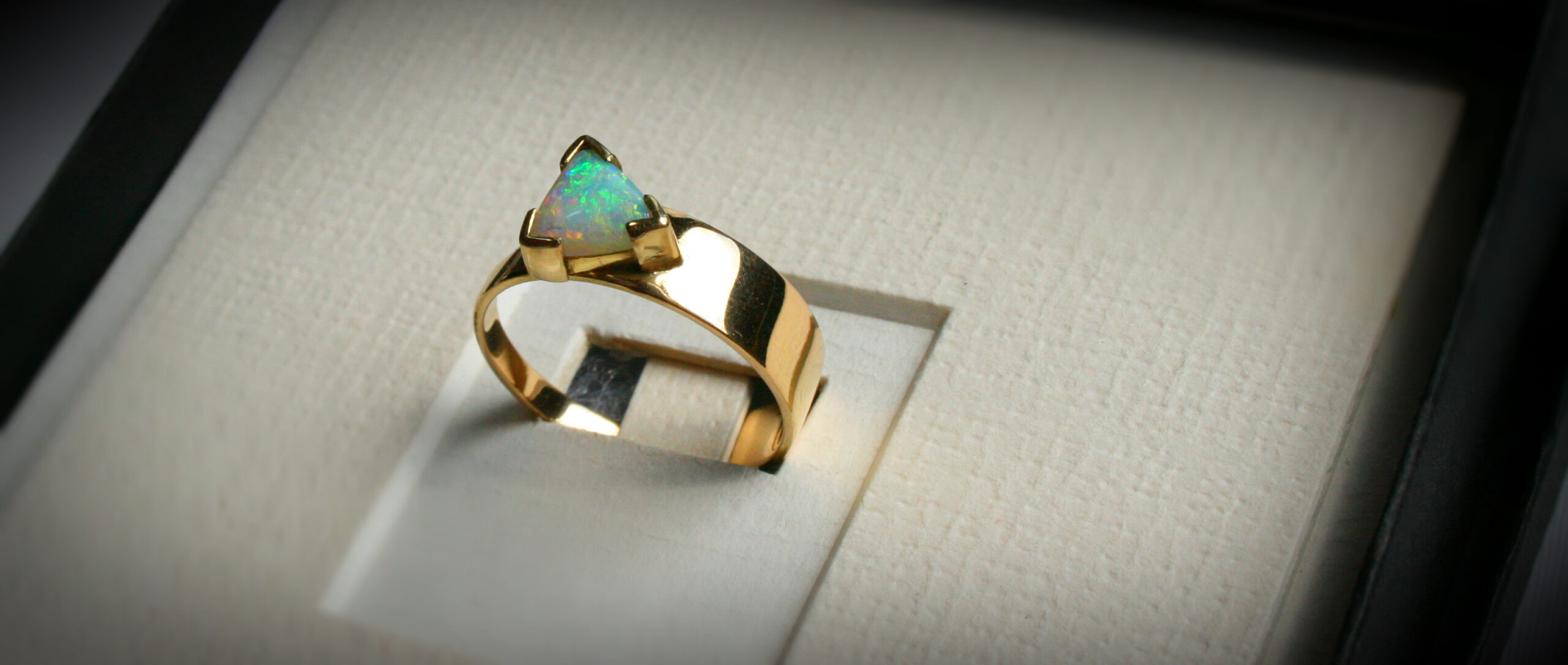 Triangle opal in 18ct gold ring